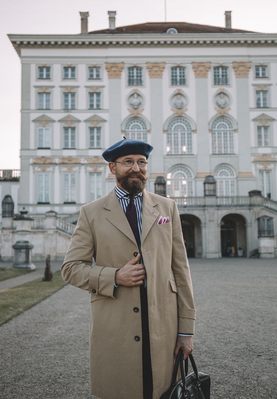 Albert in front of an old building wearing a beret